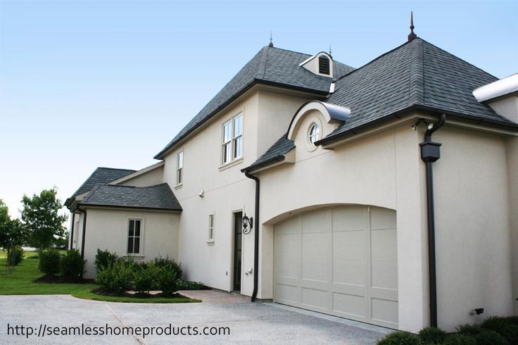 a large house with two garages on the side