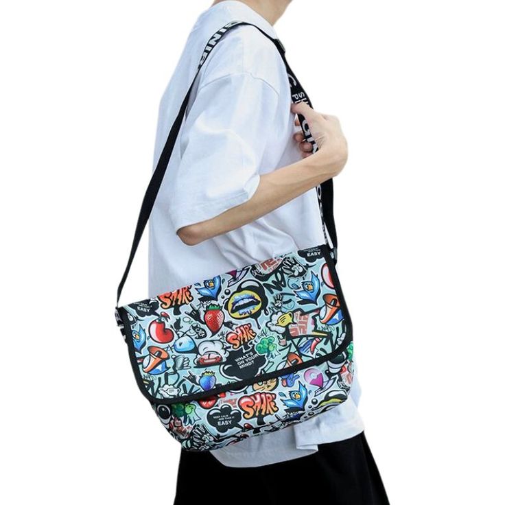 Dive into a world where art meets daily life with the Graffiti Messenger Bag. Celebrating the vibrant and free spirit of street art, this nylon bag is not just a fashion accessory; it's a statement. Each design, carefully curated, resonates with the raw energy of urban landscapes. But it doesn't stop at just making heads turn. One of its standout features is its robustness, ensuring longevity. Celebrate Urban Authenticity with the Graffiti Messenger Bag When you carry the Graffiti Messenger Bag, Harajuku Style Travel Canvas Shoulder Bag, Harajuku Style Canvas Shoulder Bag For Travel, Harajuku Style Travel Shoulder Canvas Bag, Harajuku Style Shoulder Canvas Bag For Travel, Multicolor Rectangular Bags For Streetwear, Trendy Multicolor Bag For Streetwear, White Nylon Bags For Streetwear, Multicolor Casual Canvas Travel Bag, Casual Multicolor Canvas Travel Bag