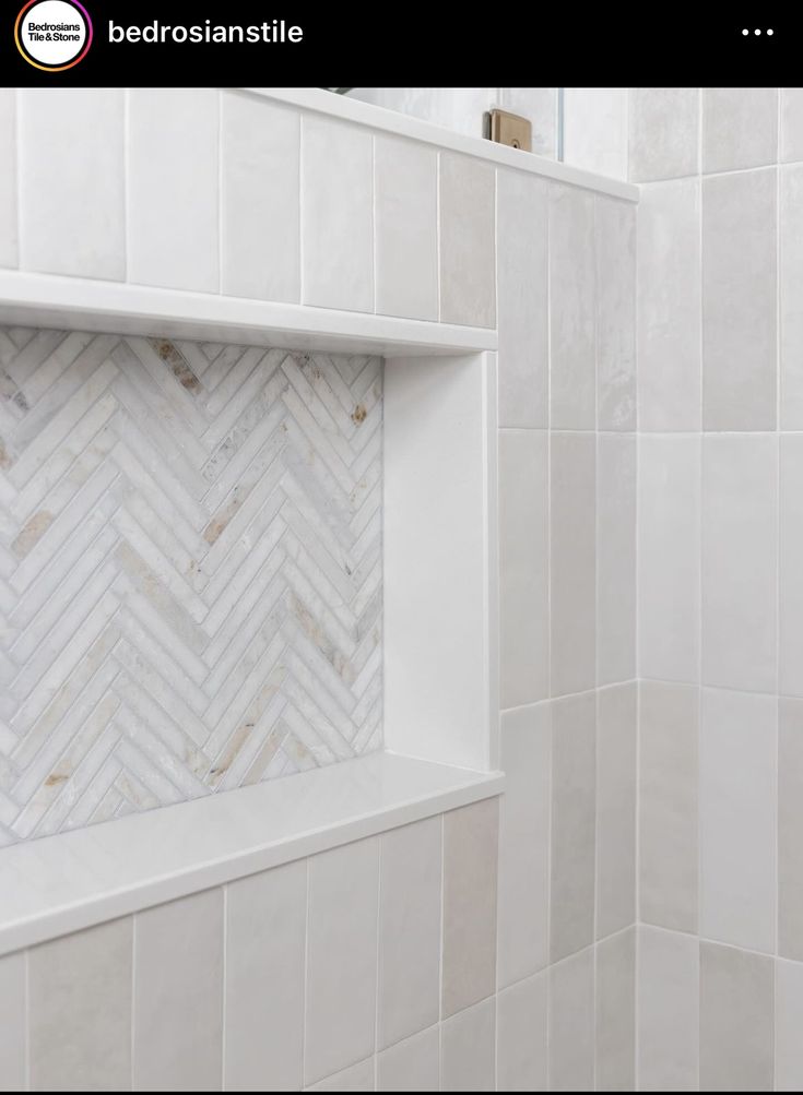 a bathroom with white tile and herringbone pattern on the shower wall is shown in this image