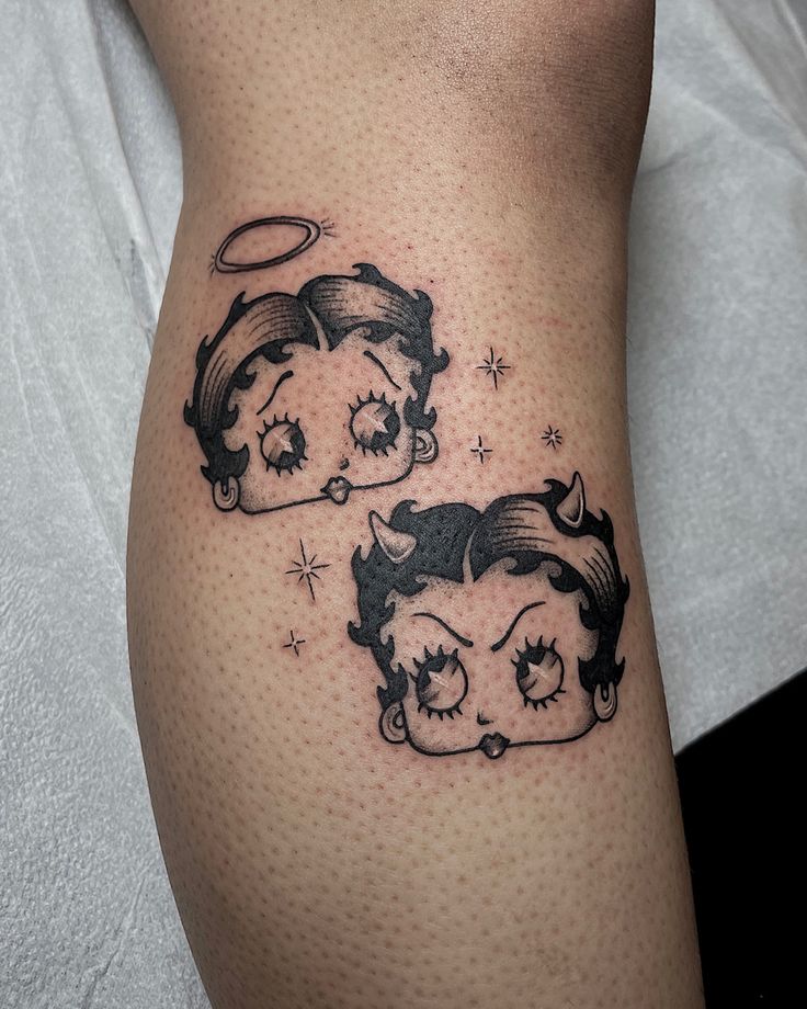 two tattoos on the leg of a woman