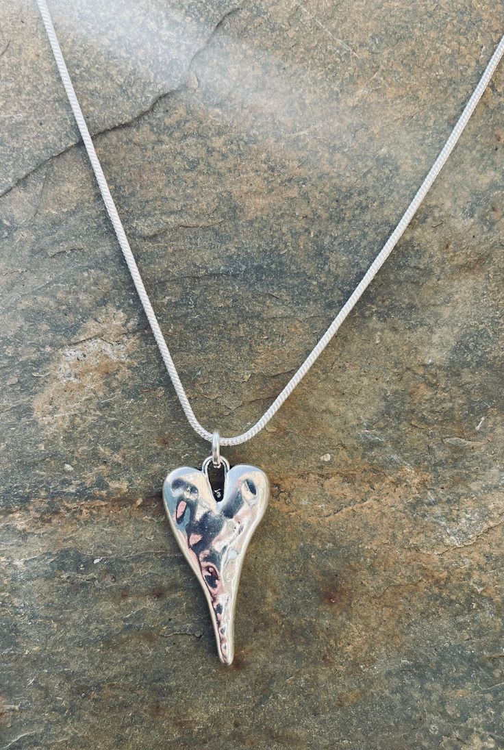 Beautiful silver plated hammered heart charm necklace with silver plated snake chain.  Size of charm is 26mm x 14mm at widest point.  Matching bracelet and earrings also available in my listings.  This can be made in various lengths so please select when purchasing. All items come tissue wrapped and in gift bag. Thank you Hammered Silver Heart Jewelry, Heart-shaped Hammered Sterling Silver Jewelry, Heart Charm Necklace, Large Bracelet, Matching Bracelet, Matching Bracelets, Snake Chain, Heart Charm, Gift Bag