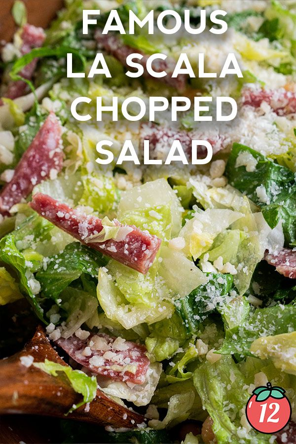 a salad with lettuce, bacon and cheese on top is shown in this image