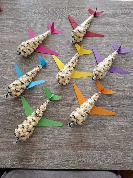 some food is laying out on a table with colorful paper sticks sticking out of it