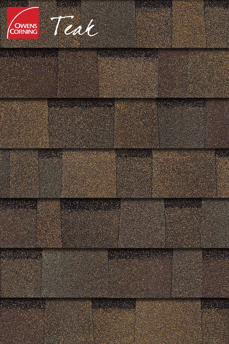 a close up view of a roof with brown shingles and white lettering on it