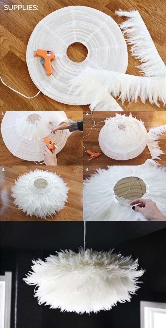 some white feathers are being used to make a chandelier