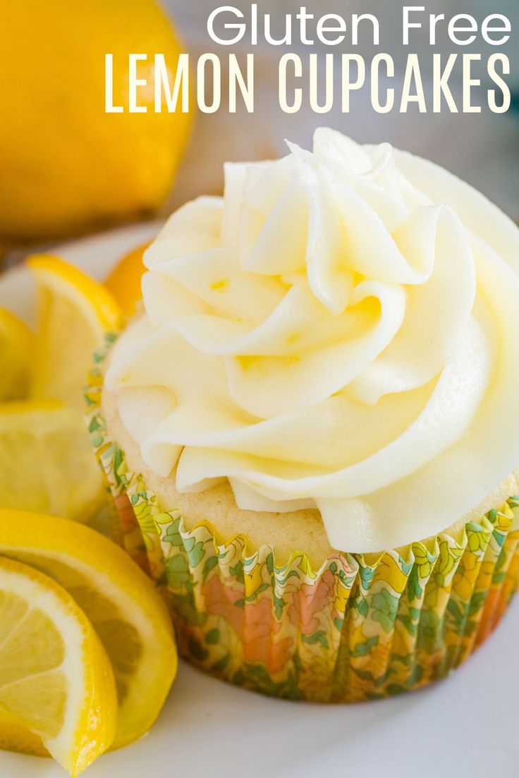 a close up of a cupcake on a plate with lemons in the background