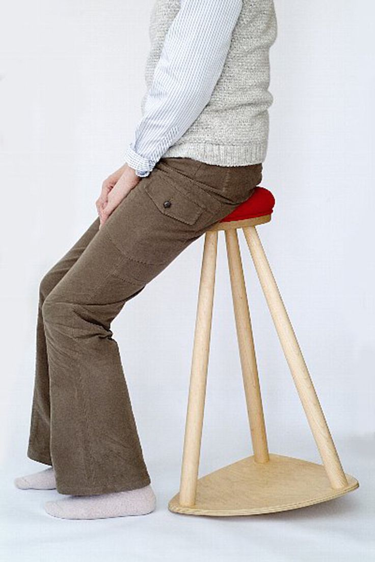 a person standing on a stool with their legs crossed and feet bent back to the side