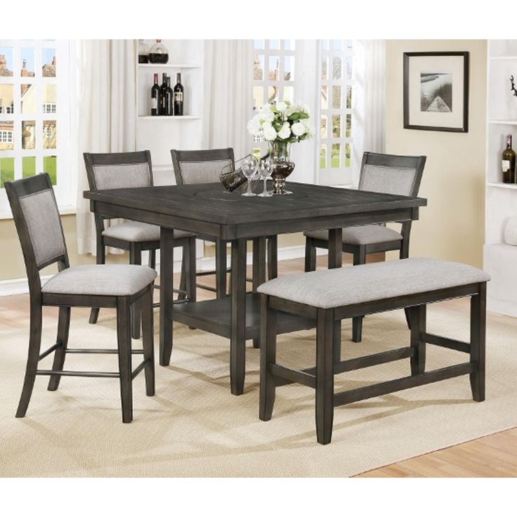 a dining room table with six chairs and a bench