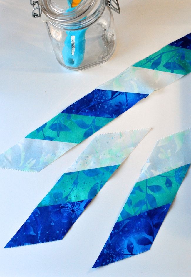 some blue and white tape sitting on top of a table next to a glass jar