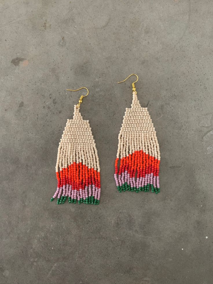 two pairs of beaded earrings with red, white and green fringes on them