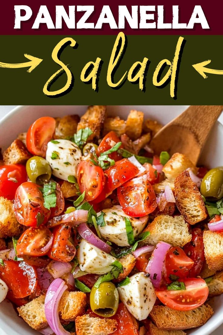 a white bowl filled with bread, tomatoes and olives