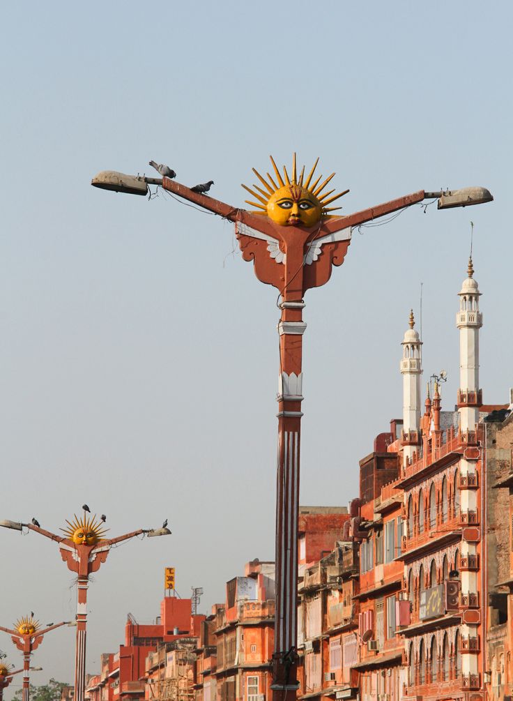 an ornate street light in the middle of a city