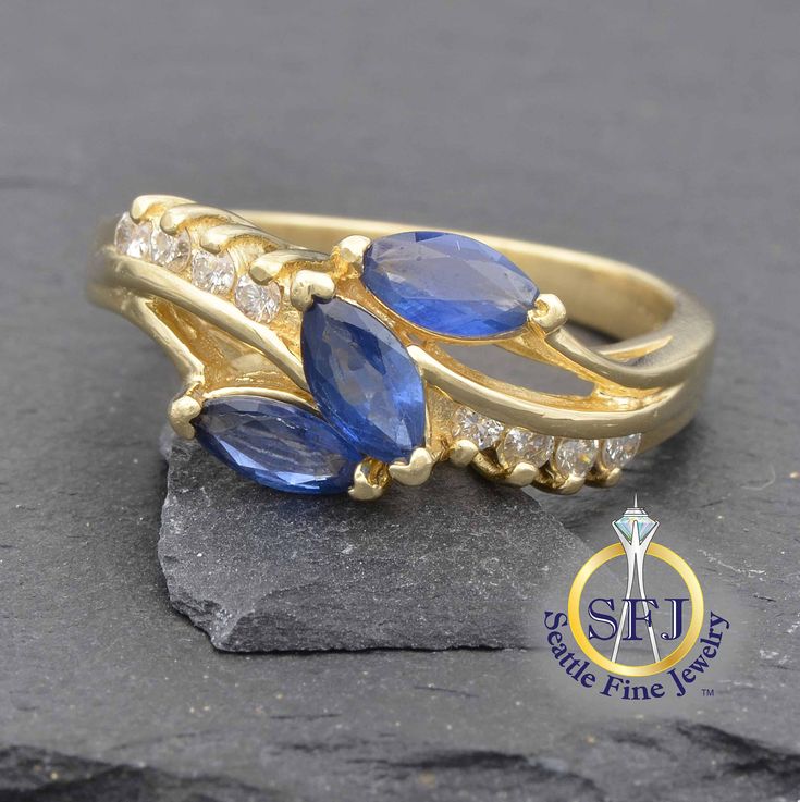 "Restored Vintage Sapphire And Diamond Ring, Solid 14K Yellow Gold METAL: Solid Yellow Gold, Stamped 14K MAIN GEM: Natural Sapphires -- 3 Marquise ACCENT GEMS: Diamonds -- 8 Round CURRENT RING SIZE:  6. (Expert resizing service available. Safe resize range for this ring: 5--8 1/2. See below to purchase resizing.) APPRAISED VALUE: $2,200 In this freeform design, 3 vibrant blue, marquise cut natural sapphires totaling nearly 3/4 carat are arrayed in a diagonal golden swoop.  Meeting them in the mi Marquise Sapphire Ring With Vvs Clarity For Anniversary, Gold Multi-stone Cluster Ring For Anniversary, Marquise Cut Multi-stone Sapphire Ring For Anniversary, Anniversary Sapphire Ring Marquise Cut Multi-stone, Anniversary Multi-stone Marquise Cut Sapphire Ring, Marquise Cut Multi-stone Anniversary Rings, 14k Gold Marquise Sapphire Ring For Anniversary, Collectible Fine Jewelry Sapphire Ring, Collectible Yellow Gold Rings With Accent Stones