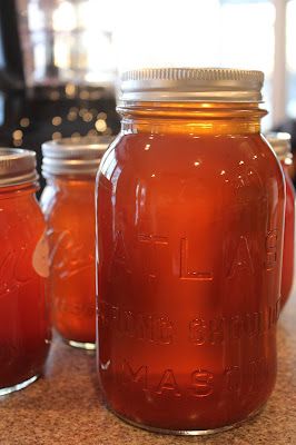 three jars filled with liquid sitting on top of a counter