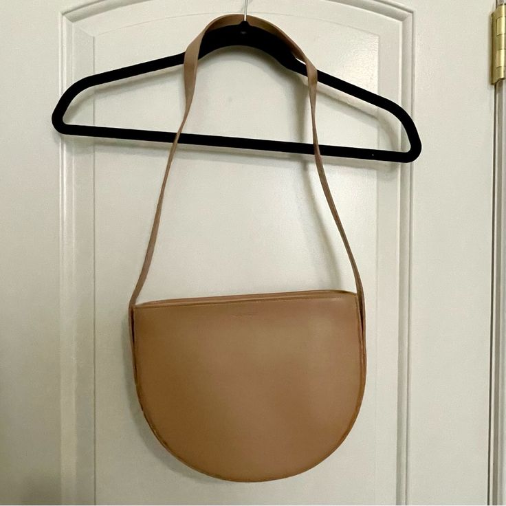 Genuine Leather Crescent Bag Brand New, Never Worn Can Be Worn As A Shoulder Or Crossbody Bag Zippered Top 14 Inch Shoulder Drop 10 Inch Width Purchased For $120 Tan Shoulder Flap Bag For Daily Use, Daily Use Tan Shoulder Flap Bag, Tan Flap Bag For Everyday Use, Chic Saddle Bag With Adjustable Strap For Shopping, Beige Saddle Shoulder Bag For Shopping, Beige Shoulder Saddle Bag For Shopping, Modern Saddle Bag For Shopping, Tan Clutch Bag For Everyday Use, Crossbody Shoulder Bag With Magnetic Closure For Shopping