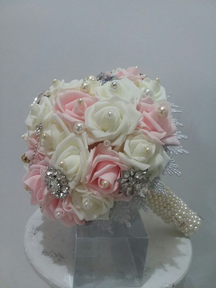 a bridal bouquet with pearls and roses