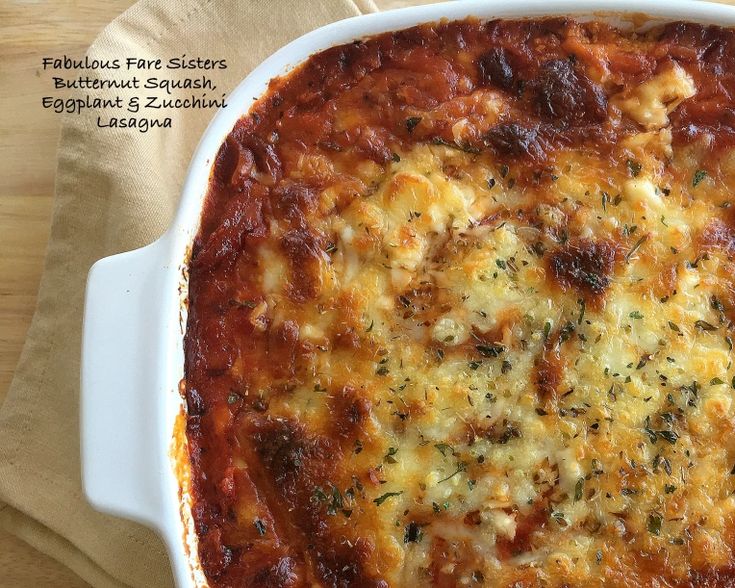 a casserole dish with meat and cheese in it on a wooden table top