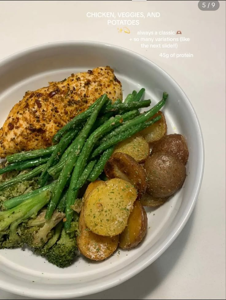 a white plate topped with chicken, potatoes and green beans