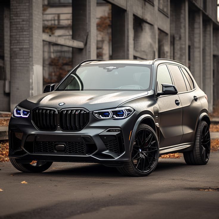 the new bmw x5 suv is parked in front of an old building