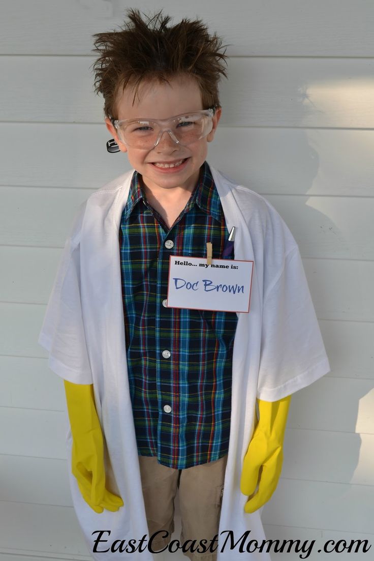 a young boy dressed up as a doctor in front of a white wall with yellow sleeves