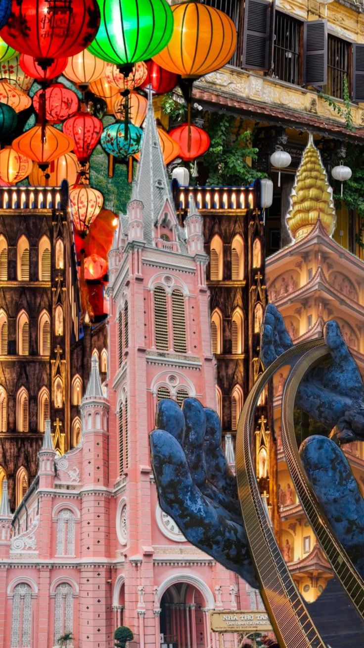 many colorful lanterns hanging from the side of a tall building with mountains in the background