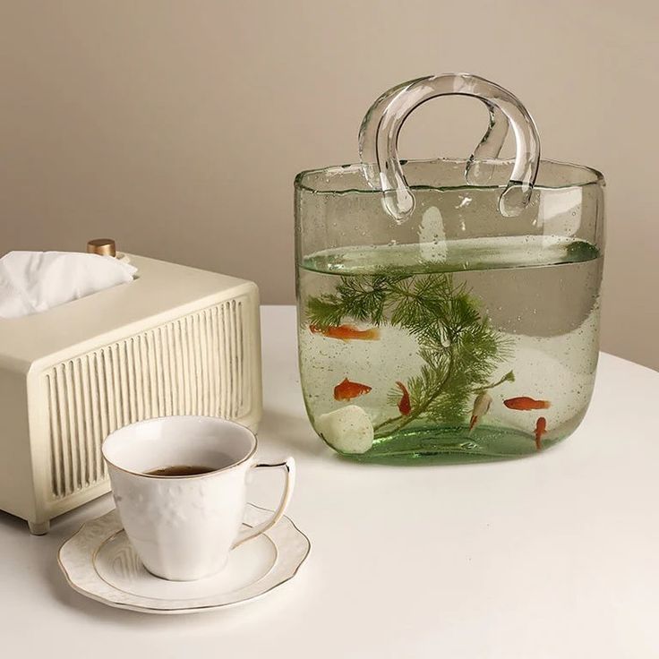 this vase bag reminds me of the coperni glass bag shop here: https://cremecloud.net/products/bag-vase?ref=bb997 or link on my story Bag Flower Vase, Creative Fish Tank, Fish Tank Home, Bag Vase, Glass Bag, Flower Table Decorations, Round Gift Boxes, Acrylic Vase, Spring Wedding Decorations