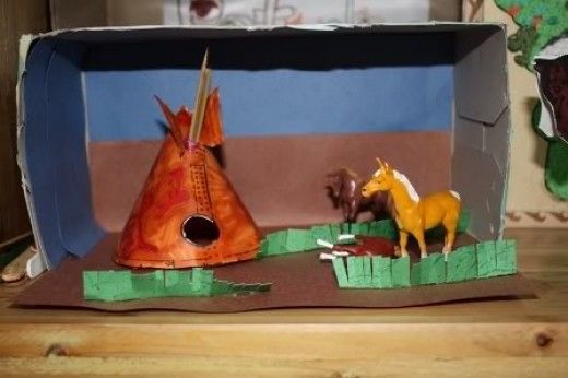 a cardboard box that has some animals in it and a horse on the other side