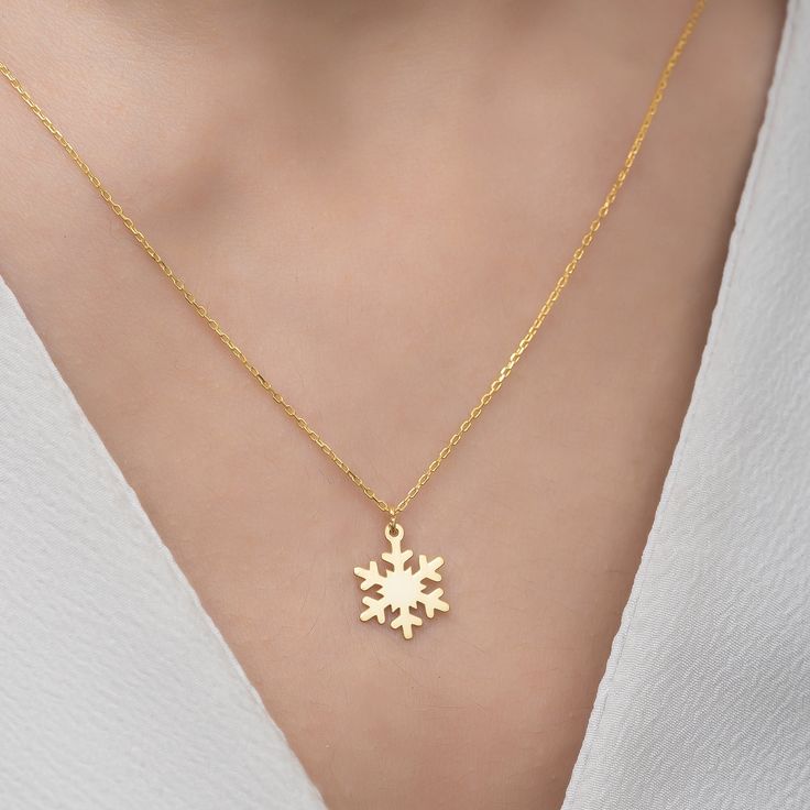 ✥ The perfect Christmas present, this Snowflake Necklace with a 14K Solid Gold Pendant combines festive elegance with classic luxury. The necklace, which is made of brilliant 14K solid gold, has a detailed snowflake design that exquisitely embodies the charm of winter. Any holiday ensemble gains a sophisticated touch from the fine gold and intricate workmanship. This snowflake pendant is a wonderful gift that will provide warmth and brightness to her holiday season and become a treasured addition to her jewelry collection. It is ideal for celebrating Christmas or surprising someone special. ✦ Metal Details✧ Metal Type: Solid Gold✧ Metal Purity: Available Options:14K | 18K✧ Metal Tone: Yellow Gold | White Gold | Rose Gold✧ Metal Certification: IDI Metal Authenticity Certificate✦ Chain Detai Winter Necklace, Snowflake Necklace, Snowflake Pendant, Gold Snowflake, Snowflake Design, Bridal Bands, Jewelry Images, Rose Gold Metal, Engagement Ring Wedding Band