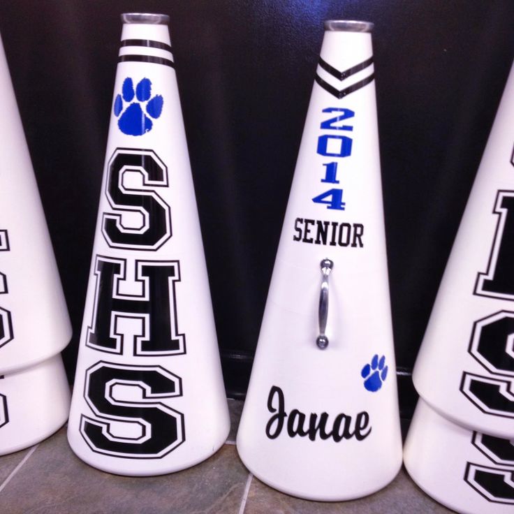 four white cones with black letters and paw prints on them