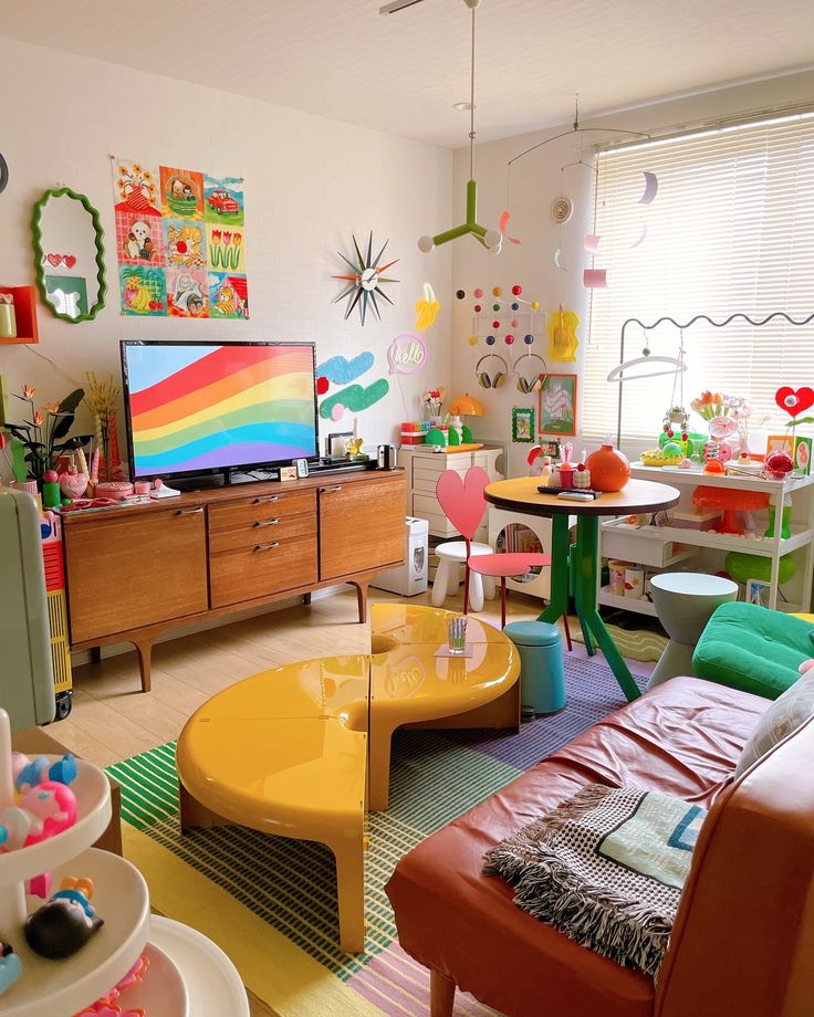 a living room filled with lots of furniture and colorful decor on the walls, including a television