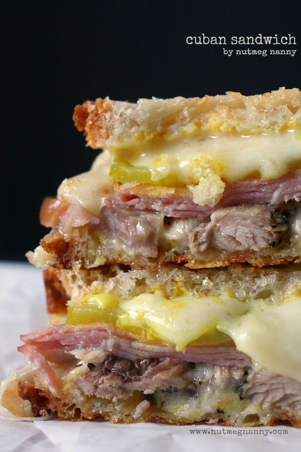 two sandwiches stacked on top of each other with cheese and meat in the middle,