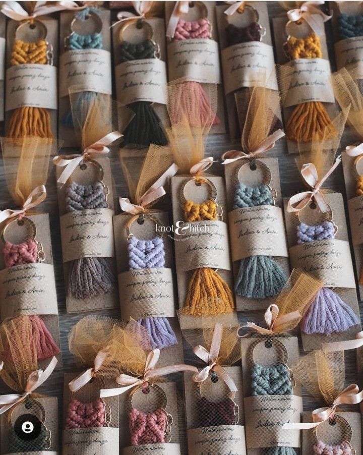 many different colors of yarn are on display in small tags with ribbons tied around them