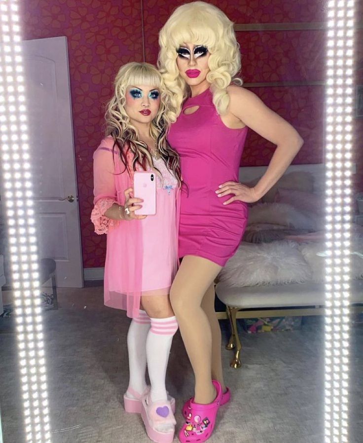 two women dressed in pink posing for the camera