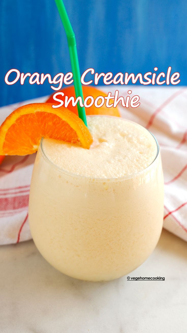 orange creamsice smoothie in a glass with an orange slice on the rim