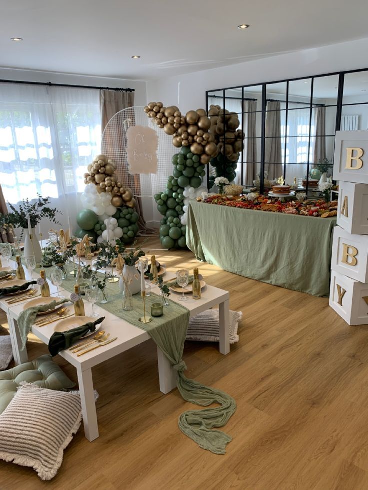 a dining room filled with lots of tables covered in green and white decorations on top of hard wood flooring