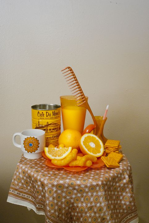 a table topped with oranges and other items