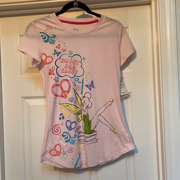 New With Tags! Official Disney Brand Tinkerbell Shirt In Light Pink. Please See Photos For Measurements, Juniors Size 7-9. From A Smoke Free And Pet Free Home. Casual Pink Shirt For Disney Fan Events, Disney Cotton T-shirt For Spring, Spring Disney T-shirt For Fan Events, Disney Cotton Tops For Spring, Disney Crew Neck Tops For Spring, Spring Disney Style Short Sleeve Tops, Tinkerbell Clothes, 2000s Stuff, Tinkerbell Shirt