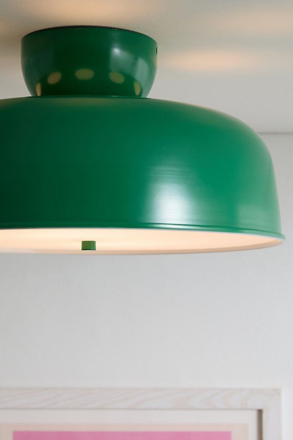 a green light hanging from the ceiling in a room