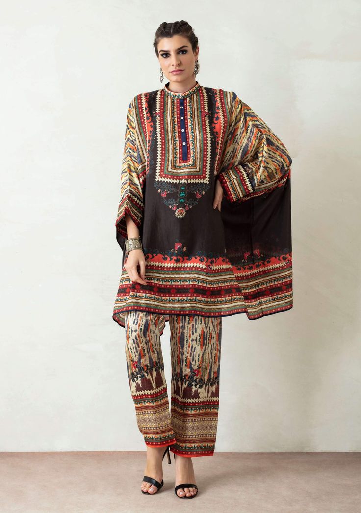 Editor's Note Band Collar Tunic With Cuffs & Printed Pallazo Pant With Front Belt Back Elastic Color: Black Fabric: Silk And Satin Care: Dry Clean Only About the Designer Rajdeep Ranawat, Indian artisan skills, and techniques are utilized to produce fine embroidered, sequinned, beaded motifs and designs. Further, original digital and block prints in generic western Silhouettes create a novel blend. Using the finest materials, weaves, metallic threads, beads, pearls, sequins and SWAROVSKI element Pallazo Pant, Collar Kurti, Rajdeep Ranawat, Asymmetric Tunic, Short Tunic, Tunics Online, Tunic Pattern, Embroidered Tunic, Pakistani Outfits