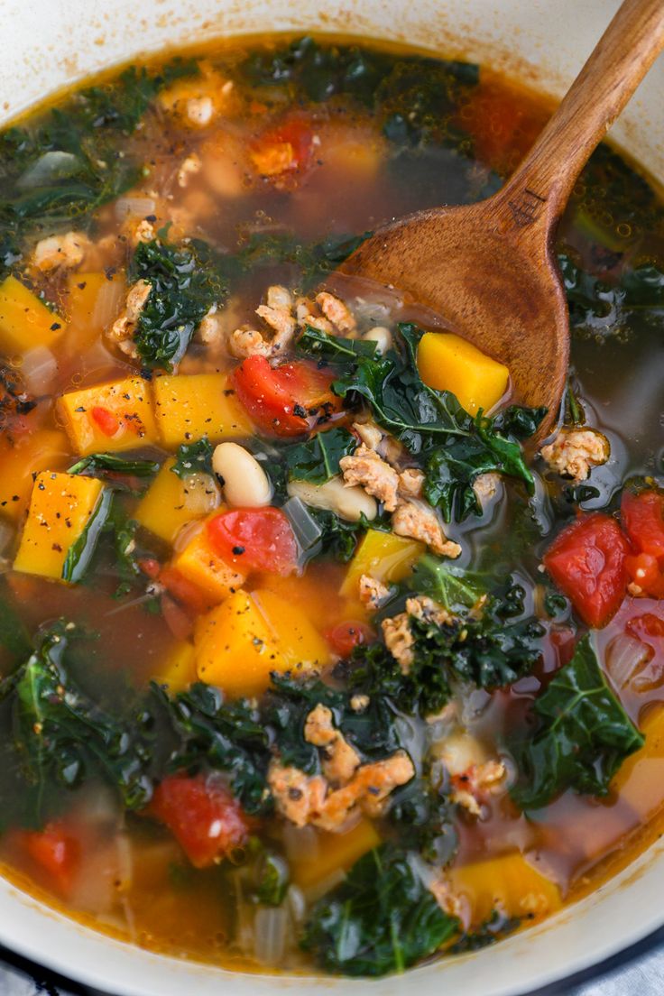 a white bowl filled with soup and vegetables