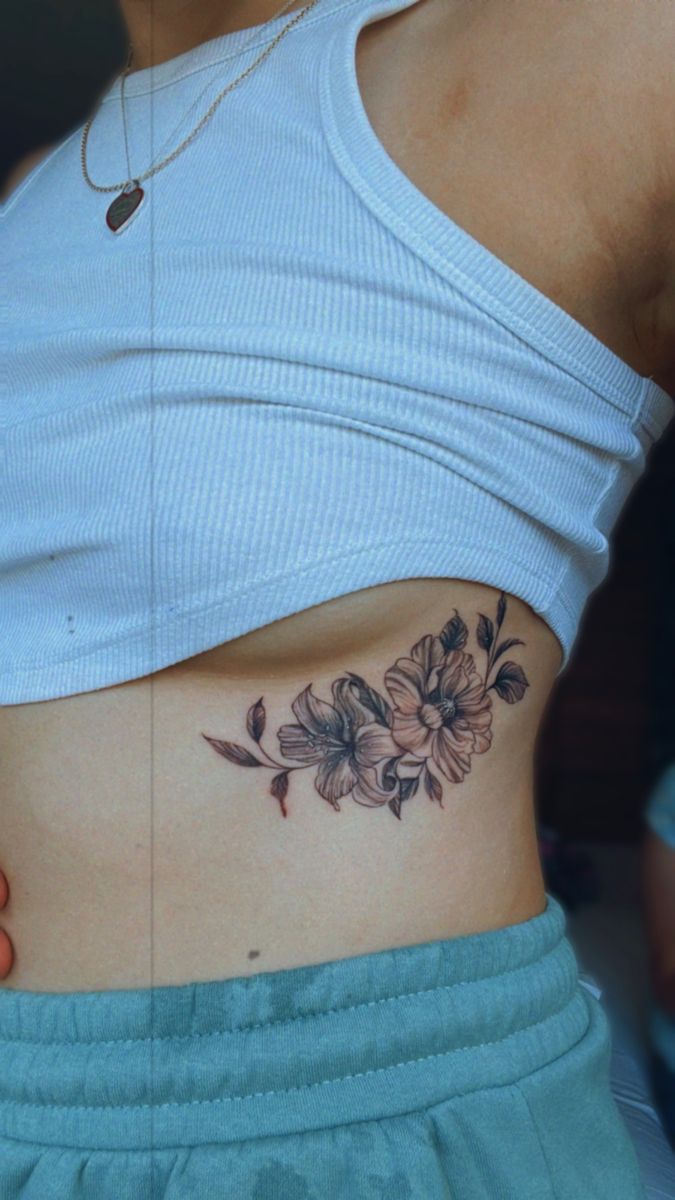 a woman with a flower tattoo on her stomach