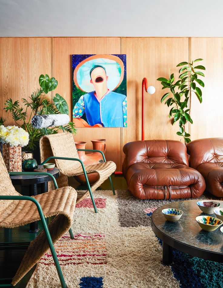 a living room filled with furniture and a painting on the wall