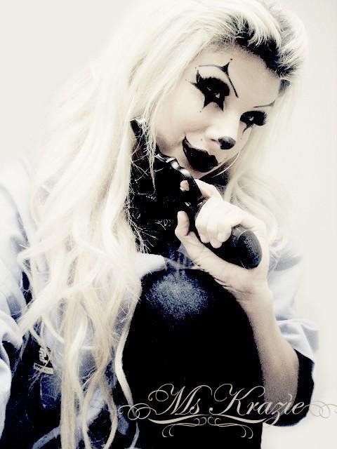 a woman with white hair and black makeup