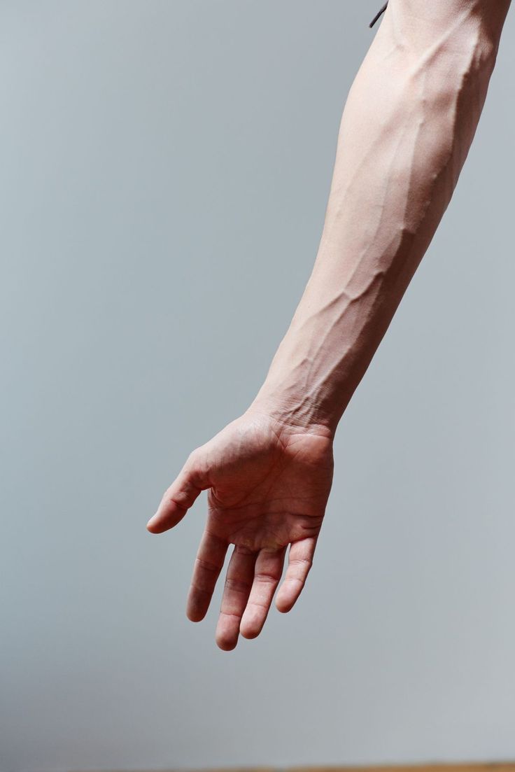 a person's arm and hand reaching for something