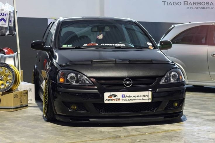 a black car parked next to two other cars