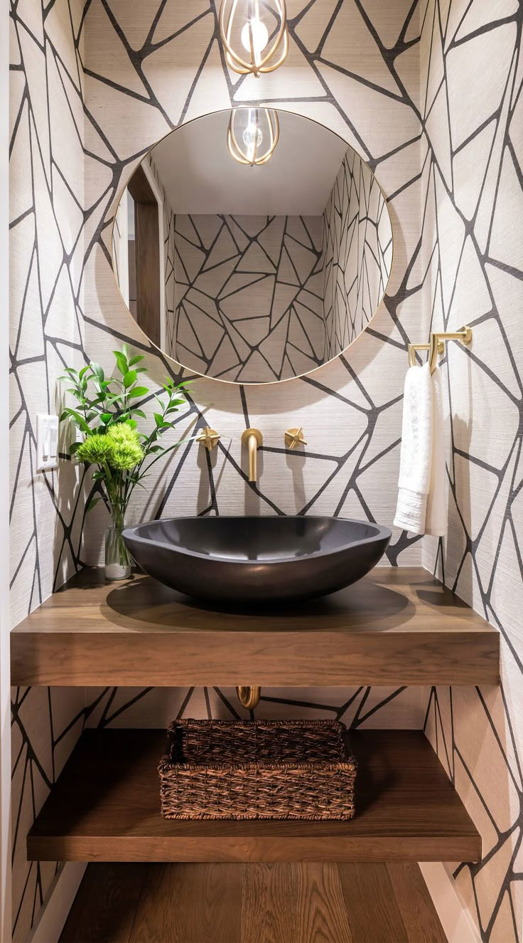 a bathroom sink with a mirror above it and a plant on the counter in front of it