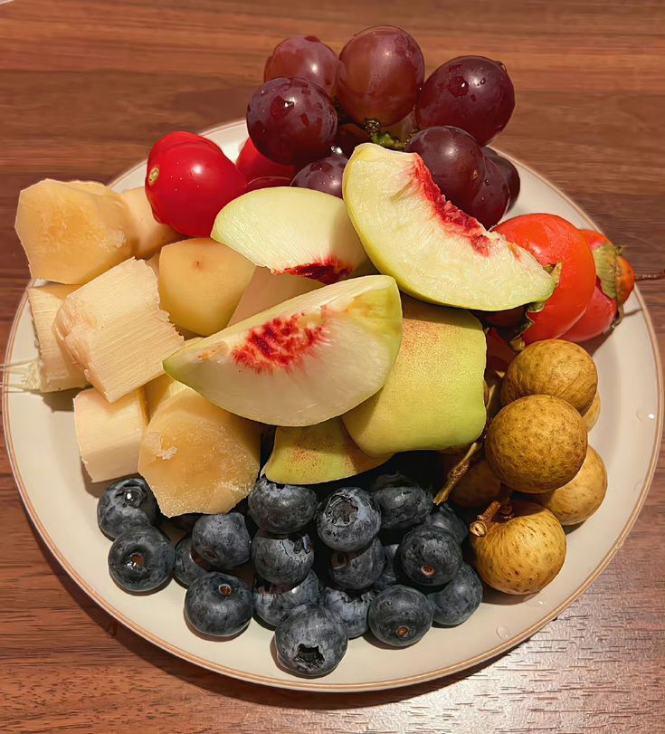 a white plate topped with fruits and vegetables