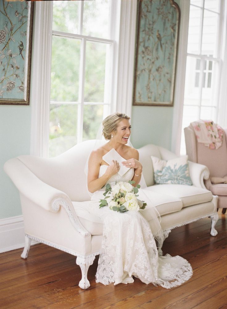 a woman sitting on top of a white couch