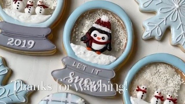 decorated cookies in the shape of snowmen and penguins