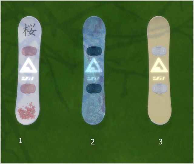 three snowboards with different designs and numbers on them